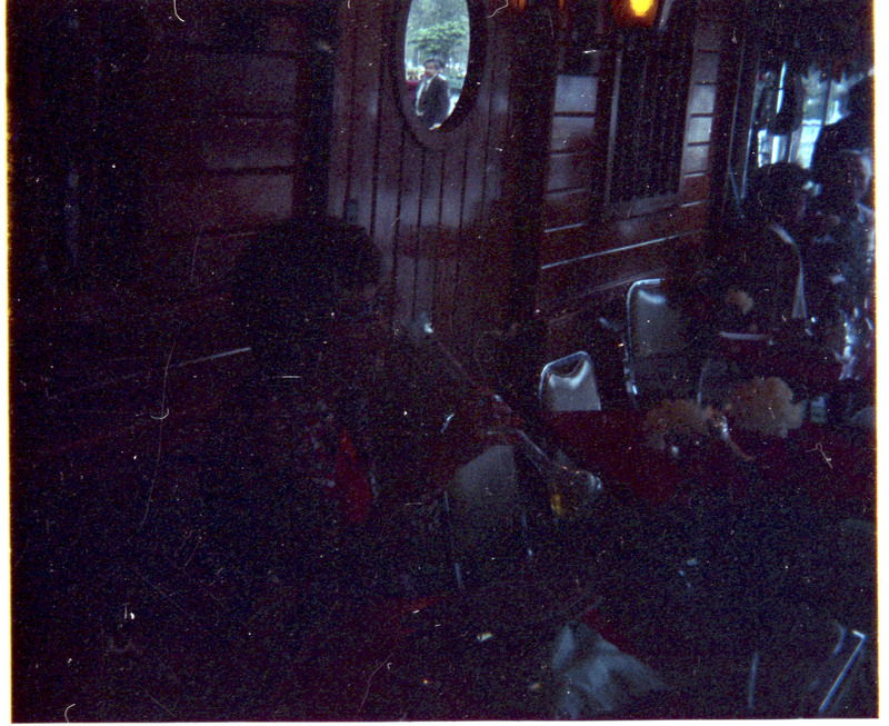 A photograph of unnamed people in a restaurant. The people are sitting at tables.