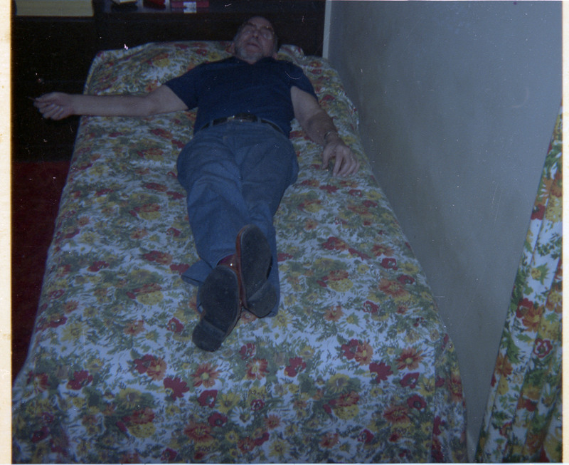 A photograph of Donald Crabtree lying on a bed.