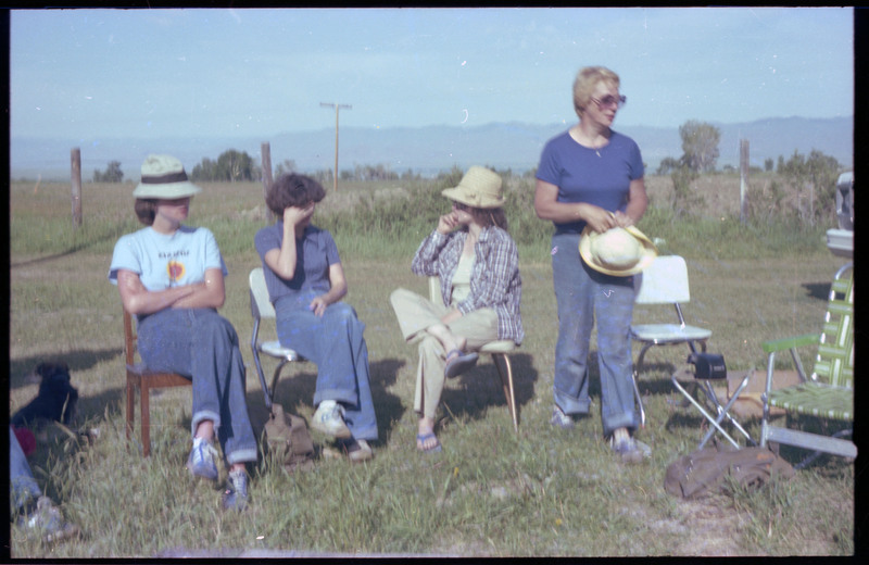 A photo of a group of people sitting outside, talking with one another. Associated item numbers: ce_b83_f2-item4-029 and ce_b83_f2-item4-031 through ce_b83_f2-item4-042.