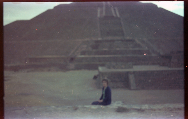 A photograph of Evelyn Crabtree sitting in front of the Pyramid of the Sun in Teotihuacan.