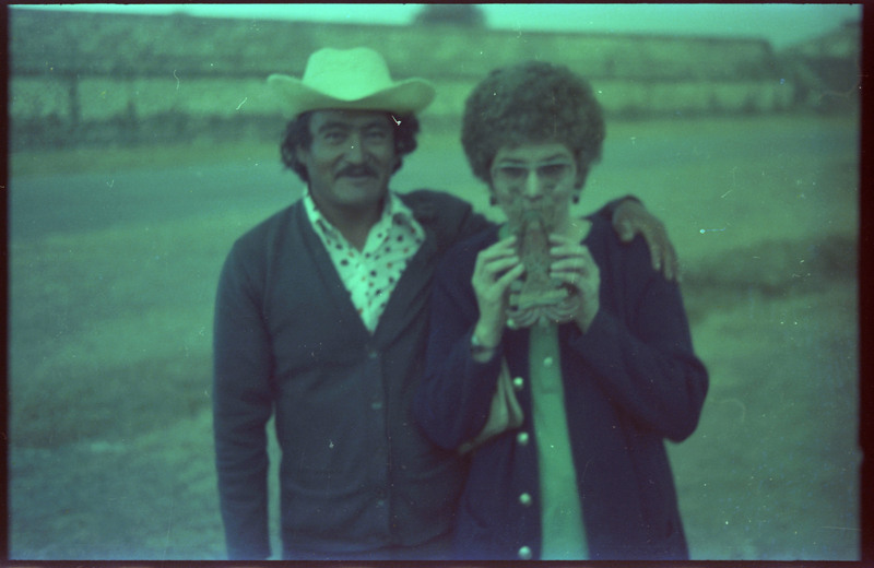 A photograph of Evelyn Crabtree posing for the camera with an unnamed man. Evelyn Crabtree also appears to be holding an unknown item.