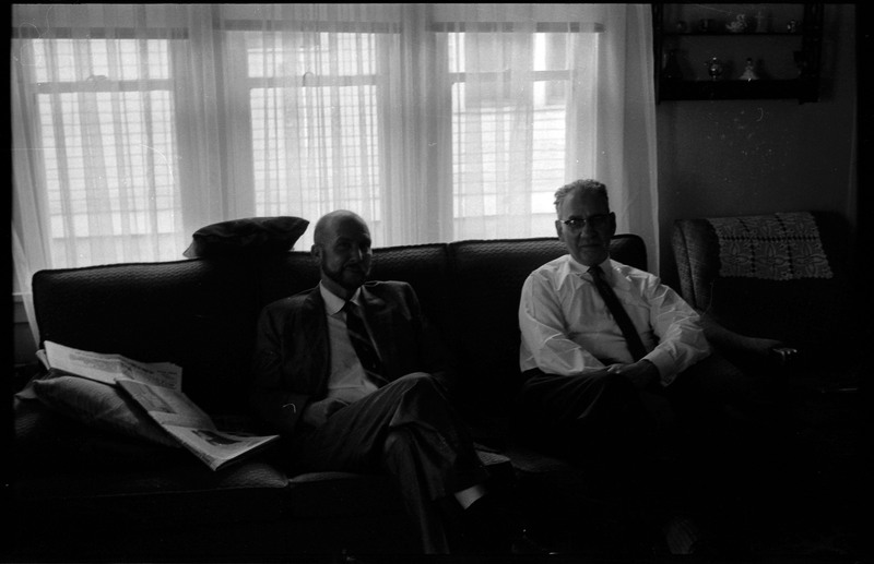 A photograph of Donald Crabtree and another man sitting on a couch.