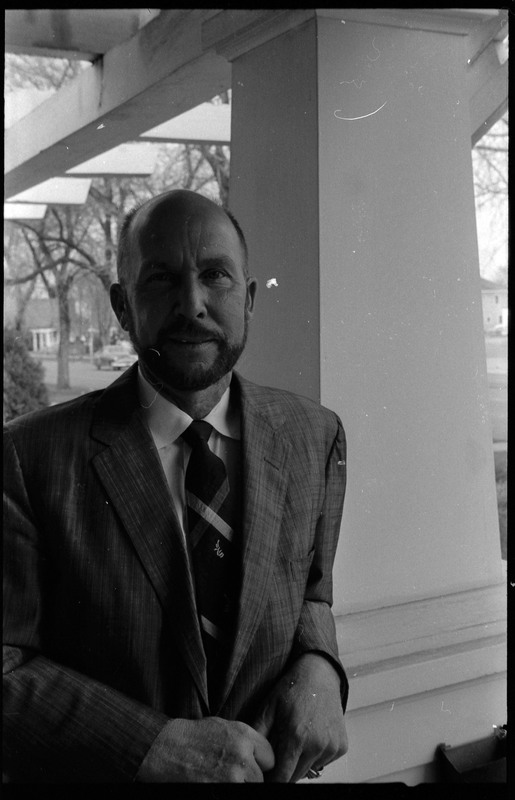 A photograph of Donald Crabtree standing on a porch.