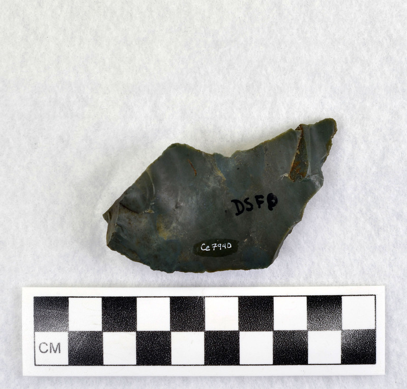 Part of Donald E. Crabtree's experiments with heat treating stone. Ce.7940 is a fragment of Ce.7939. This specific experiment had the stone heat treated from 8:00am to 3:00pm in electric furnace peaking at 1700 degrees F. The object is a percussion flake and is associated with Ce.7892-Ce.7939.