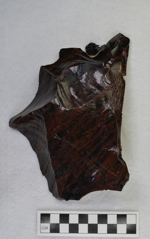 One of several macro flakes from Glass Butte, obsidian by Donald E. Crabtree. broken/glued Damaged while on exhibit, 1986. Condition: was partially repaired, see CE_CB_D2_1212-1213 for other pieces of this macro flake