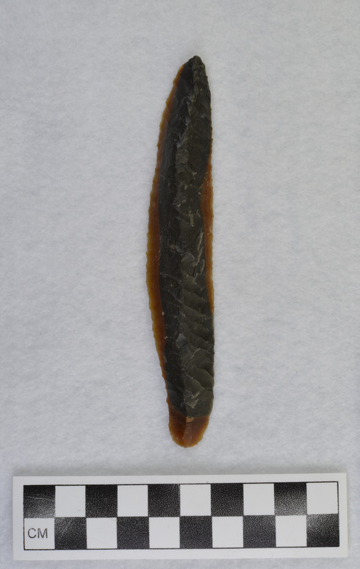 While visiting Donald E. Crabtree at home in Kimberly, Idaho, Francois Bordes created this blade. (GT) There is evidence of pressure flaked margins. Only worked unifacially, the dorsal side is completely pressure flaked.