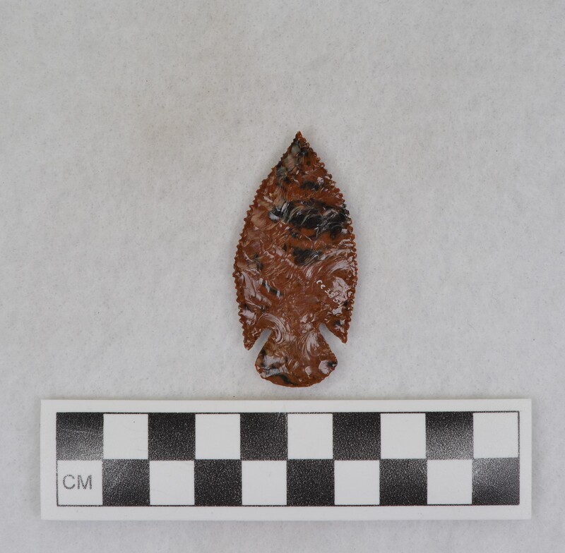 A corner notched biface made from Glass Butte, Oregon obsidian. The biface also displays super fine serrations. Made by Donald E. Crabtree sometime between 1930-1940.