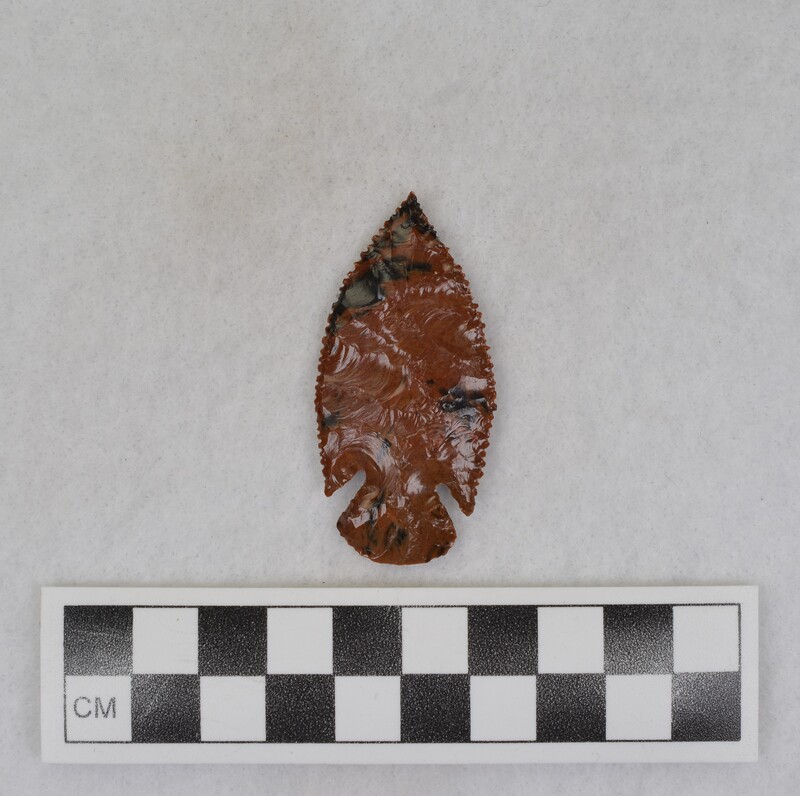 A corner notched biface made from Glass Butte, Oregon obsidian. The biface also displays super fine serrations. Made by Donald E. Crabtree sometime between 1930-1940.