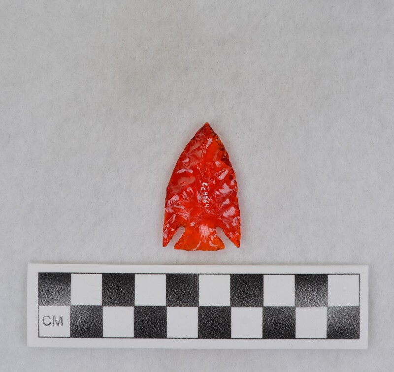 Corner notched. Material: red tail light lens.