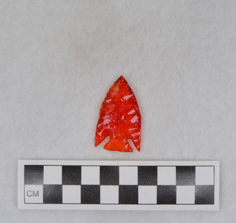 Corner notched. Material: red tail light lens.