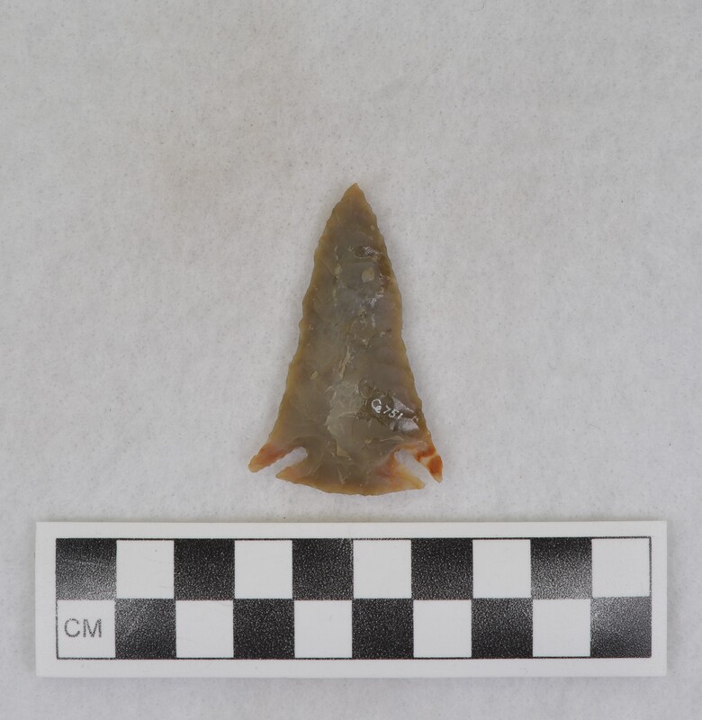 Created by Donald E. Crabtree using chert sourced from Challis, Idaho. The projectile point is corner notched.