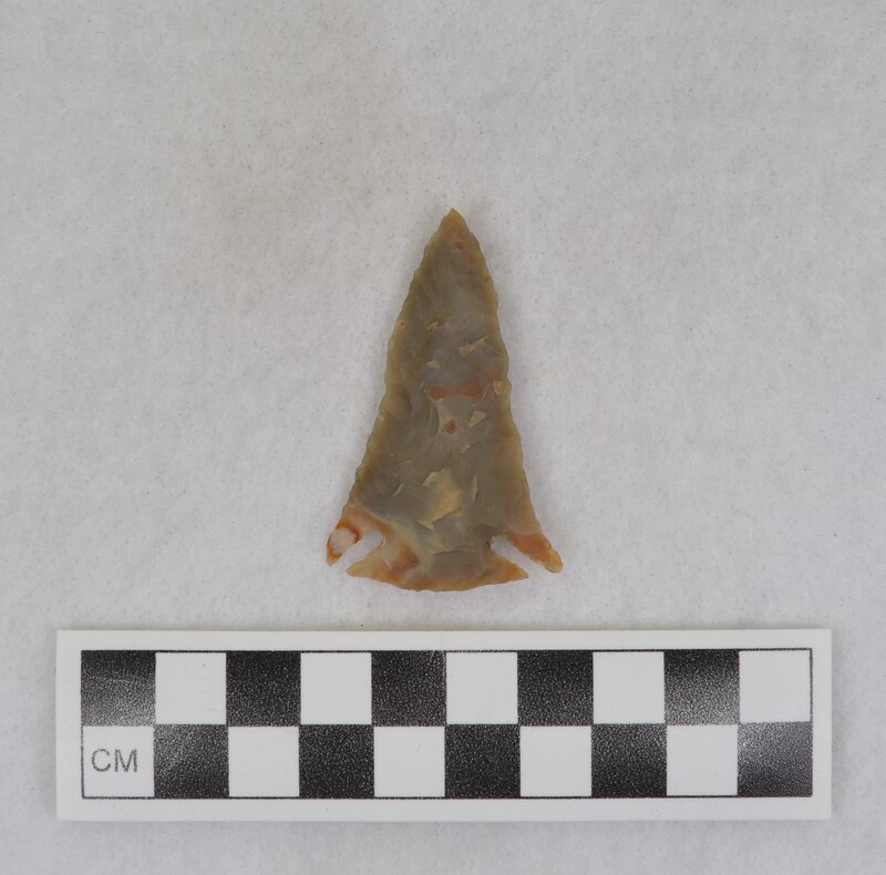Created by Donald E. Crabtree using chert sourced from Challis, Idaho. The projectile point is corner notched.