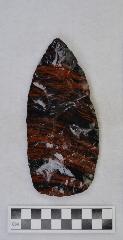 A large, mahogany obsidian biface. Donald E. Crabtree produced this biface using an antler billet.