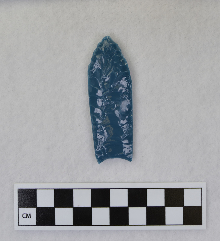 A fluted point created by Donald E. Crabtree from light blue glass as part of his fluting experiements. Associated with objects Ce.1016, Ce.1017, Ce.1019, Ce.1020.