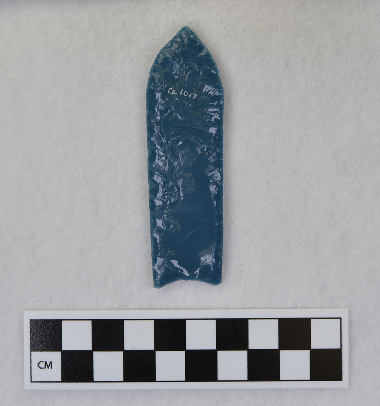 A fluted point created by Donald E. Crabtree from light blue glass as part of his fluting experiements. Associated with objects Ce.1015, Ce.1016, Ce.1019, Ce.1020.