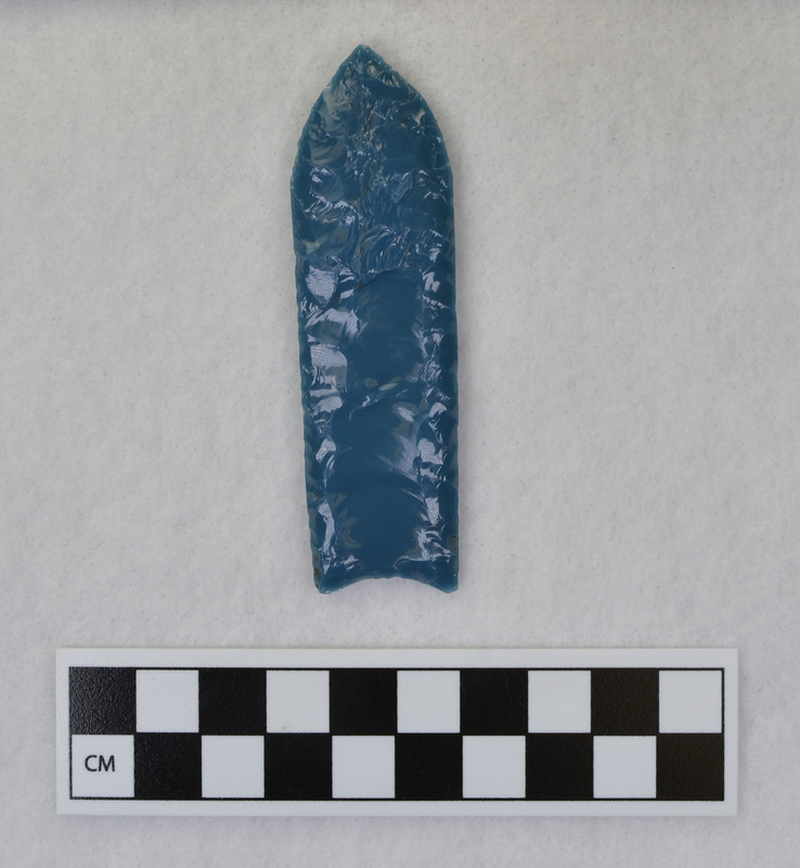 A fluted point created by Donald E. Crabtree from light blue glass as part of his fluting experiements. Associated with objects Ce.1015, Ce.1016, Ce.1019, Ce.1020.