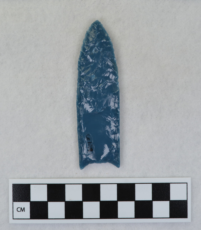 A fluted point created by Donald E. Crabtree from light blue glass as part of his fluting experiements. Associated with objects Ce.1015, Ce.1016, Ce.1017, Ce.1020.