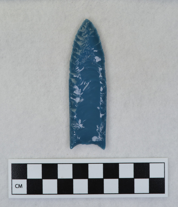 A fluted point created by Donald E. Crabtree from light blue glass as part of his fluting experiements. Associated with objects Ce.1015, Ce.1016, Ce.1017, Ce.1020.