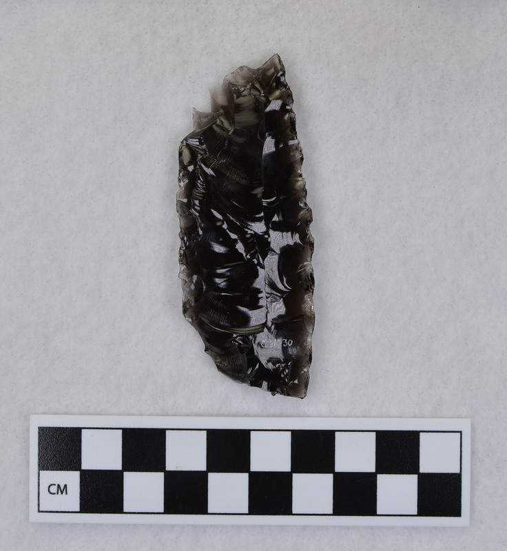 A Clovis channel flake created by Donald E. Crabtree while fluting a Clovis point. This channel flake was the result of an error in it's removal from the point.