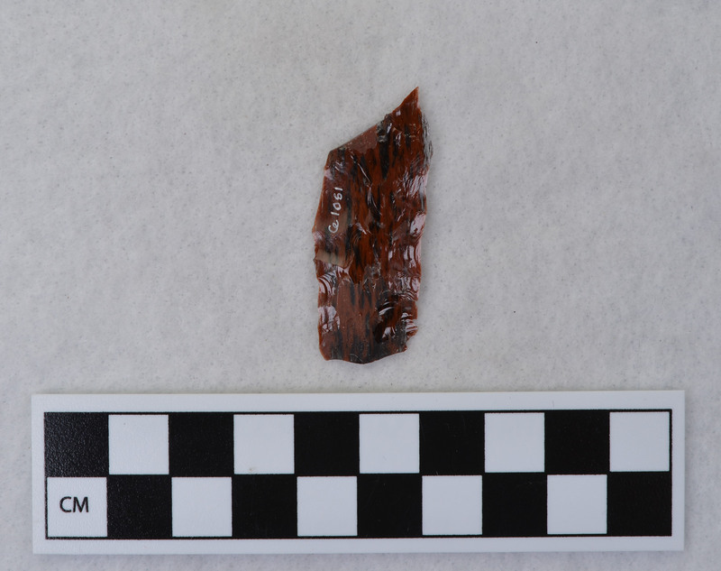 Donald E. Crabtree created this flake by removing a channel flake from the Clovis point he created, Ce.1059. The channel flake is broken and is in three fragments: Ce.1060, Ce.1062 and Ce.1063.