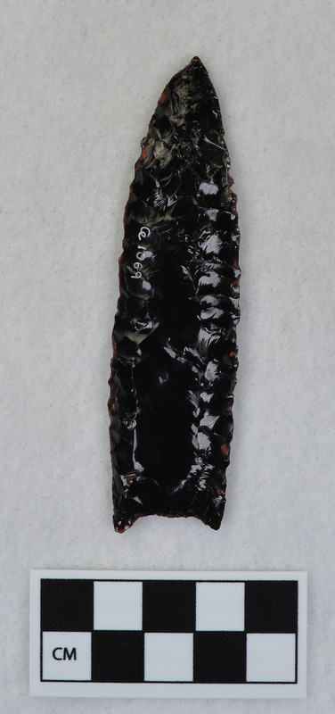 Fluted, similar to Cumberland point, Manufacture technique - held in vise and fluted by chest crutch. (GT)Associated with Ce.1070 - Ce.1073.Four flake pieces included do not seem to fit the blade. (EL)