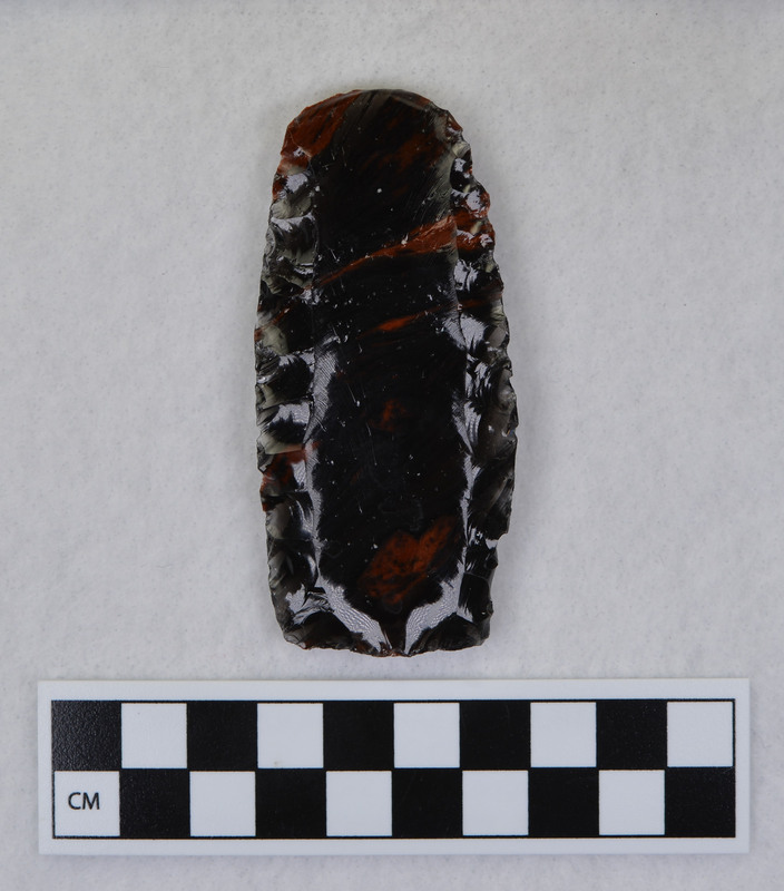 This item was created by Donald E. Crabtree during his fluting experiments. The fragmented channel flakes from this experiment are Ce.1102 - Ce.1104. This item was fluted using rock anvil to support tip and hammerstone was used to remove channel flake. Gene Titmus noted that the distal end ground and the platform were ground.
