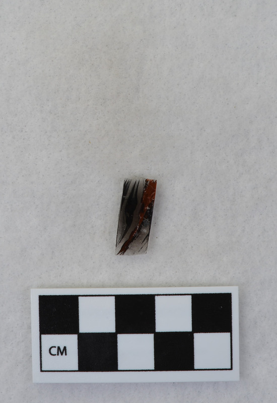 This item was created by Donald E. Crabtree during his fluting experiments. The fluted point that this flake was detached is Ce.1101. Ce.1101 was fluted using rock anvil to support tip and hammerstone was used to remove channel flake. Gene Titmus noted that the distal end ground and the platform were ground.