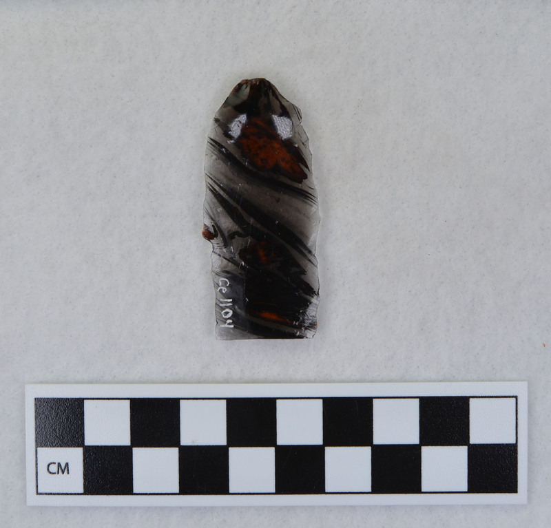 This item was created by Donald E. Crabtree during his fluting experiments. The fluted point that this flake was detached is Ce.1101. Ce.1101 was fluted using rock anvil to support tip and hammerstone was used to remove channel flake. Gene Titmus noted that the distal end ground and the platform were ground.