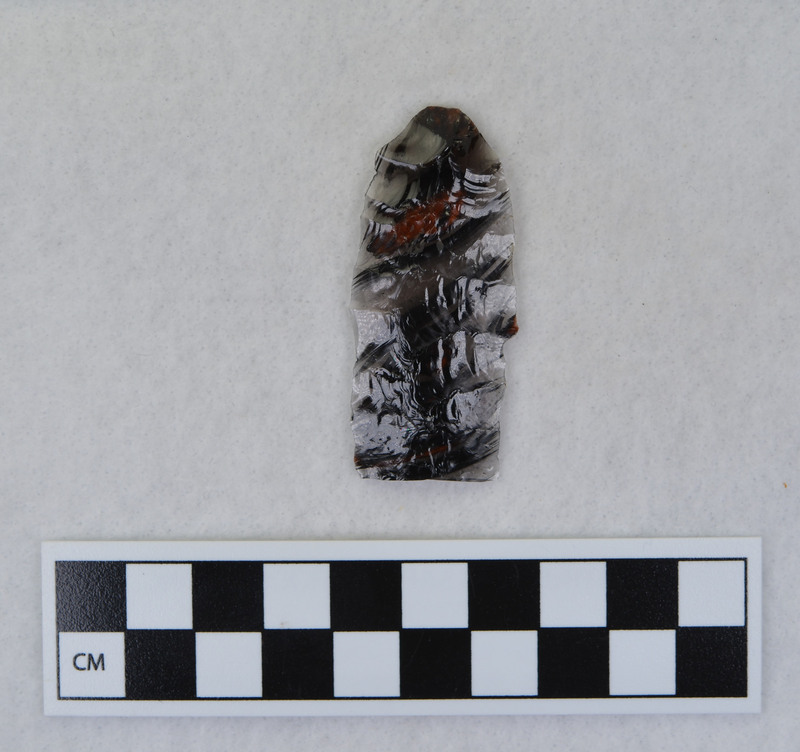 This item was created by Donald E. Crabtree during his fluting experiments. The fluted point that this flake was detached is Ce.1101. Ce.1101 was fluted using rock anvil to support tip and hammerstone was used to remove channel flake. Gene Titmus noted that the distal end ground and the platform were ground.