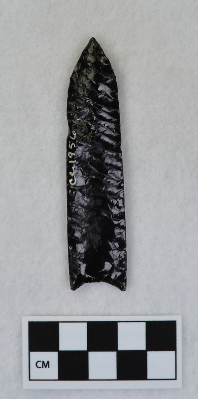 Fluted by pressure flaking, Ground almost full length of margin to facilitate holding in a vise. (JW)