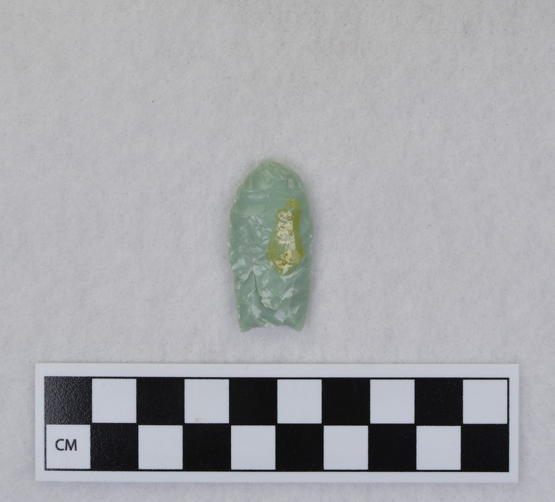 This was made by Donald E. Crabtree as part of his fluting experiments. The object was severed when second channel flake attempted. Too much mass ahead of flake caused fracture to dive inward instead of proceeding to the distal end of the point. Repaired by Crabtree. (JW)