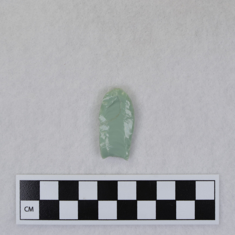 This was made by Donald E. Crabtree as part of his fluting experiments. The object was severed when second channel flake attempted. Too much mass ahead of flake caused fracture to dive inward instead of proceeding to the distal end of the point. Repaired by Crabtree. (JW)