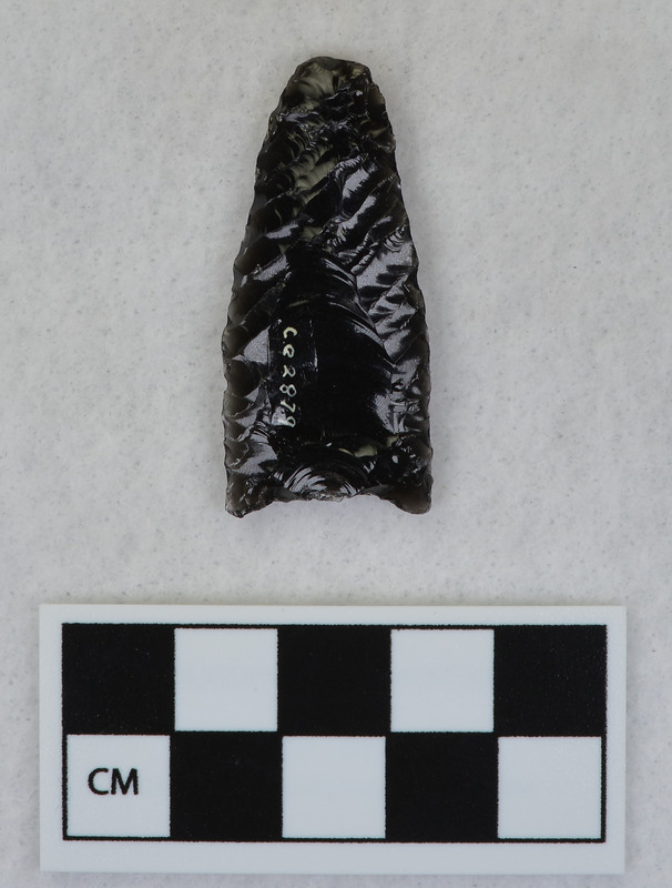 Parallel diagonal flaking, One face fluted by percussion. Tip ground and was supported during fluting process. (GT)