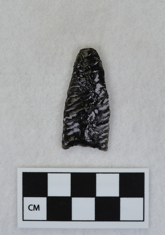 Parallel diagonal flaking, One face fluted by percussion. Tip ground and was supported during fluting process. (GT)