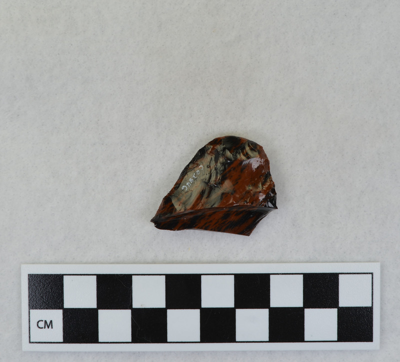 A Clovis point created by Donald E. Crabtree. This object mends with seven other objects in the collection; Ce.3845, Ce.3847 - Ce.3852. The object was made using percussion fluting with a hammerstone while the distal end rested on an anvil.