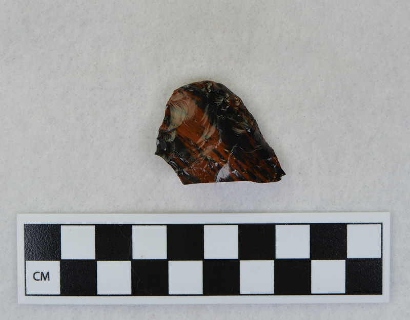 A Clovis point created by Donald E. Crabtree. This object mends with seven other objects in the collection; Ce.3845, Ce.3847 - Ce.3852. The object was made using percussion fluting with a hammerstone while the distal end rested on an anvil.