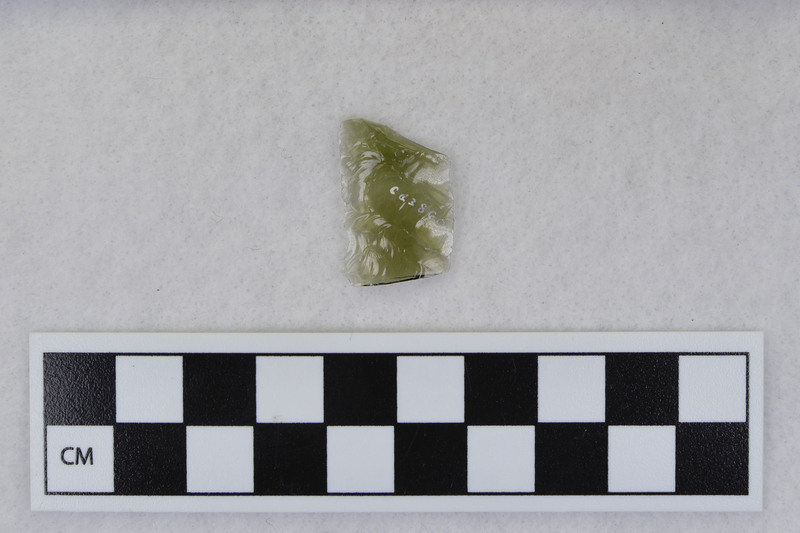 Channel, distal, mends w/Ce.3861. Ce.3860 and Ce.3861: both fragments are transparent, green and may be either glass or obsidian. (MAP)