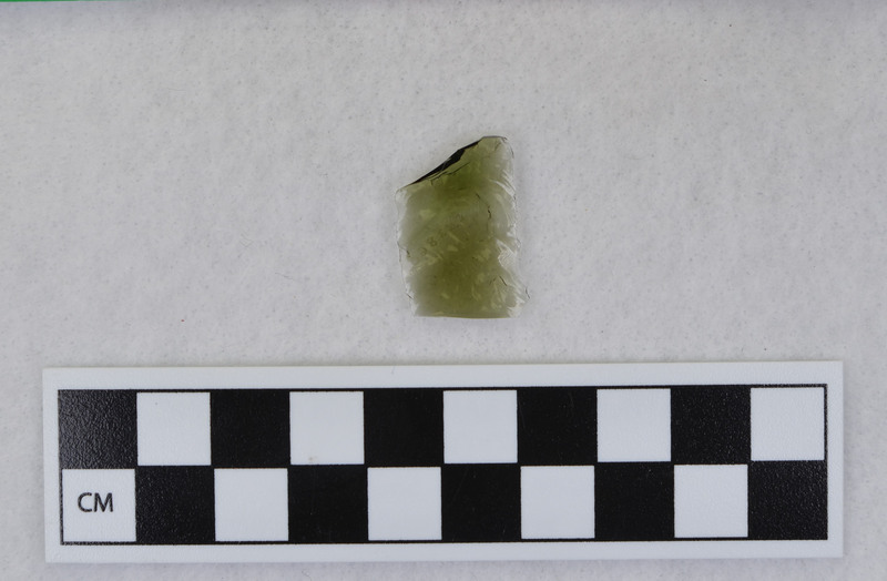 Channel, distal, mends w/Ce.3861. Ce.3860 and Ce.3861: both fragments are transparent, green and may be either glass or obsidian. (MAP)