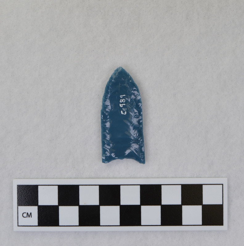 Donald E. Crabtree created this object during his Folsom fluting experiments. The basal edges are ground. It is thought by Gene Titmus that the channel flakes probably removed by vise and crutch technique. (GT)