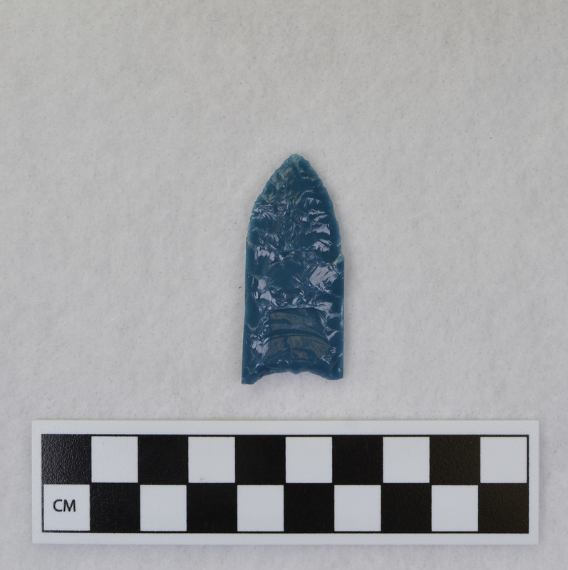 Donald E. Crabtree created this object during his Folsom fluting experiments. The basal edges are ground. It is thought by Gene Titmus that the channel flakes probably removed by vise and crutch technique. (GT)