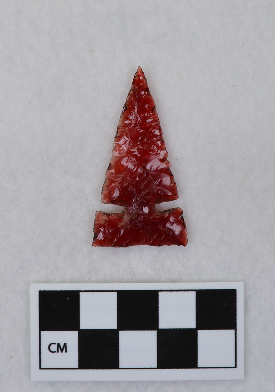 Side notched Material from tail light lens. (JW)