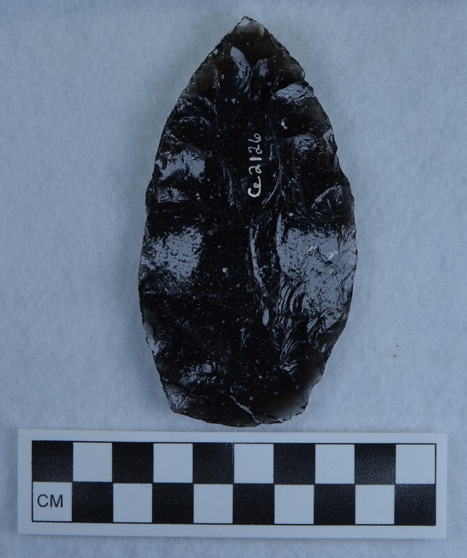 Black obsidian biface that is partially transparent around the margins as well as having some inclusions
