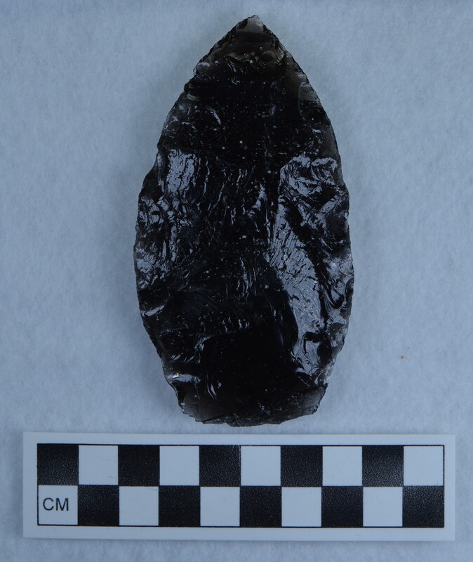 Black obsidian biface that is partially transparent around the margins as well as having some inclusions