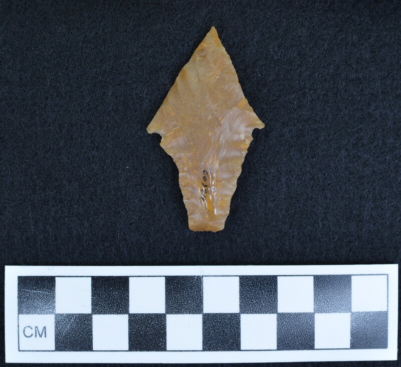 This biface was created from flint from Grand Pressigny France. The projectile point was notched, then burin flakes removed from base to notch, lastly the burin edges were pressure flaked. (GT)