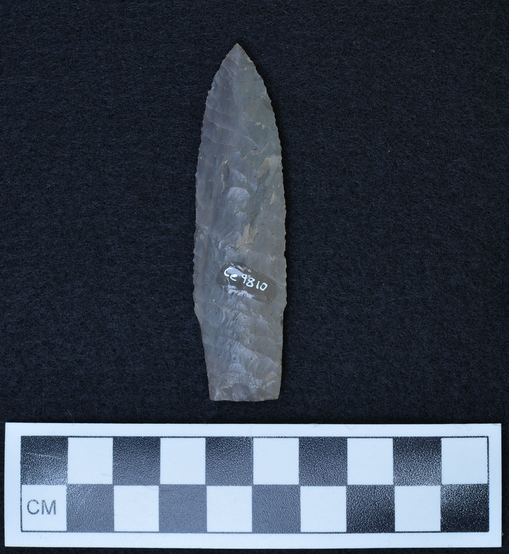 Basal ground, "Hinge fracture on one face resulted from soft spot in material (light color). (JW) Looks like Scottsbluff. (DHC)"