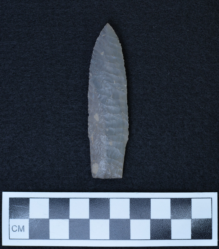 Basal ground, "Hinge fracture on one face resulted from soft spot in material (light color). (JW) Looks like Scottsbluff. (DHC)"