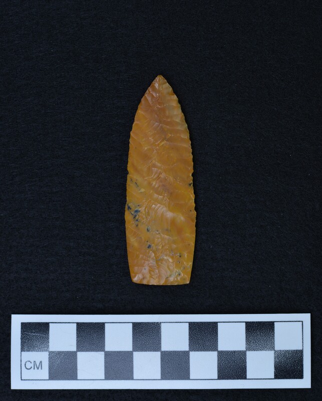 A Scottsbluff style point made by Donald E. Crabtree circa 1965. The biface exhibits heavily ground basal margins.