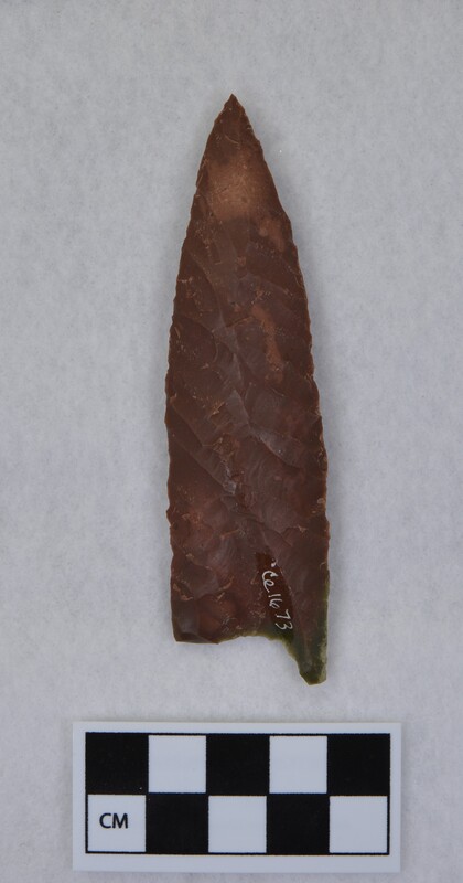 Heat treated, parallel diagonal flaking, basal margins lightly ground. This was flaked to midsection. Base thinned, one tang broken off. (GT)