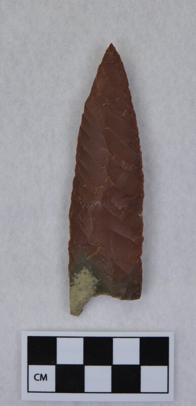 Heat treated, parallel diagonal flaking, basal margins lightly ground. This was flaked to midsection. Base thinned, one tang broken off. (GT)