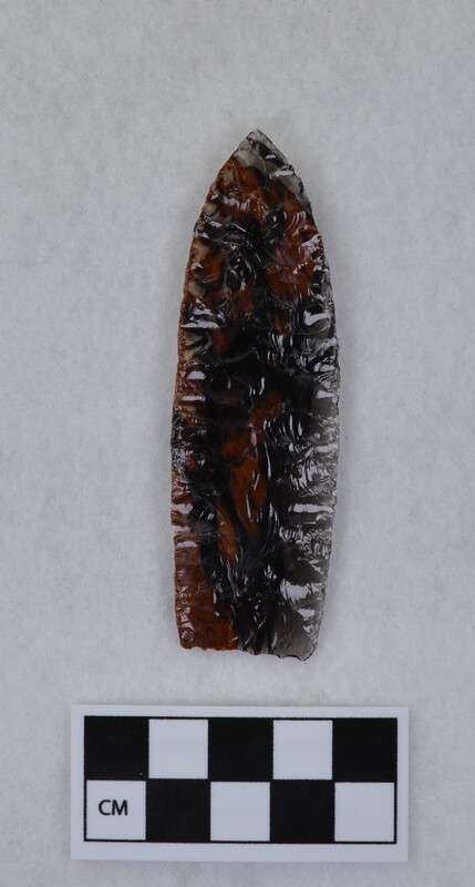 Collateral flaking, lanceolate style, basal margin lightly ground, base thinned